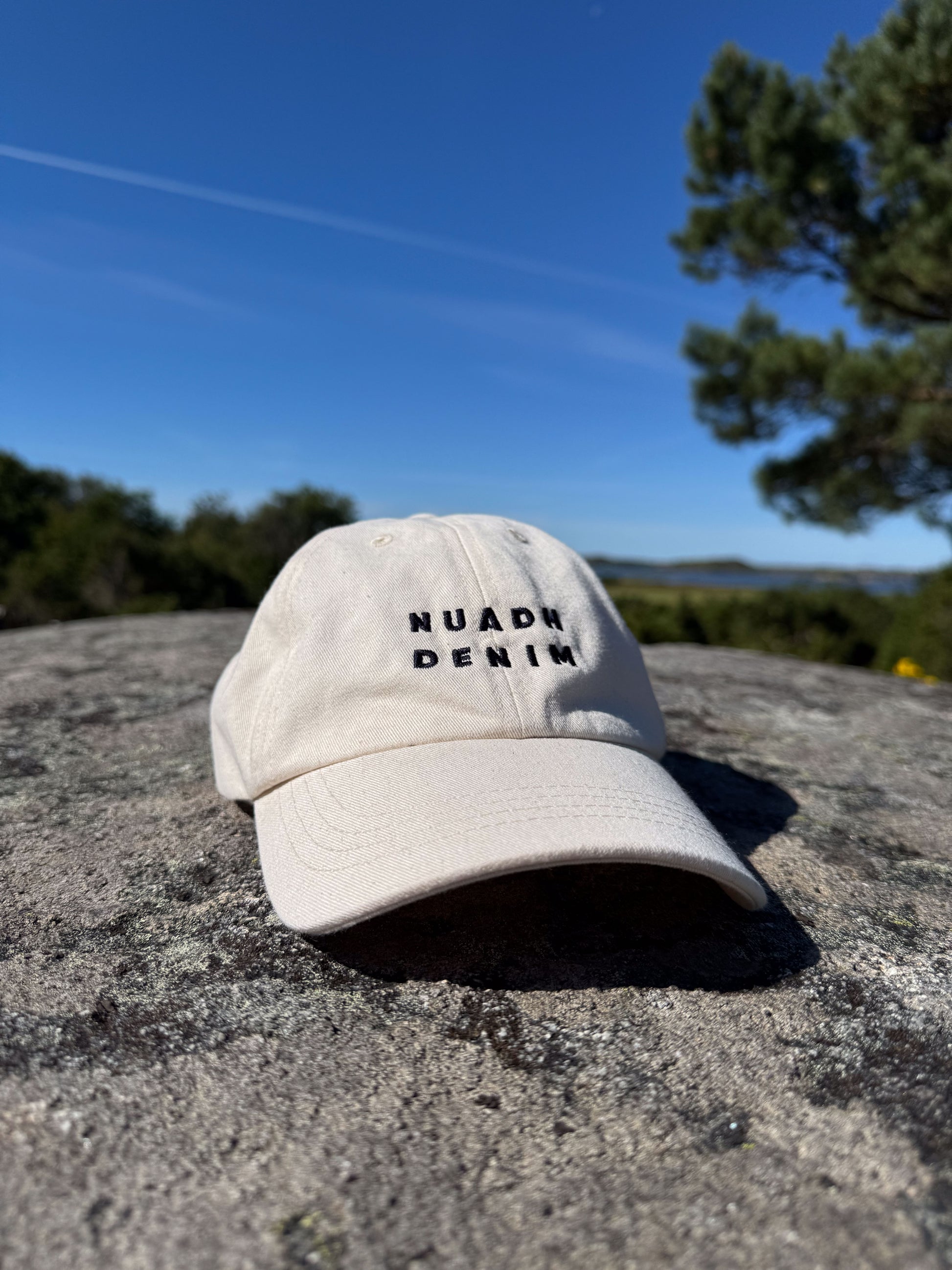 NUADH DENIM Six-panel baseball cap crafted from unbleached natural cotton twill with self coloured topstitching. Embroidered NUADH DENIM logo on the front panel. 
Six-paneled Soft unstructured crown. 

NUADH DENIM | Catacol Bay Dad cap | 100% Organic unbleached cotton| Made in Scotland.